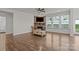 Spacious living room featuring hardwood floors, a stone fireplace, and large windows at 187 Longleaf Dr, Mooresville, NC 28117