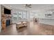 Spacious living room with a fireplace, hardwood floors, and an adjacent breakfast area at 187 Longleaf Dr, Mooresville, NC 28117