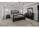 Primary bedroom features a tray ceiling, bedside tables, and an elegant dark wood bedroom set at 187 Longleaf Dr, Mooresville, NC 28117