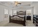 Spacious primary bedroom with a tray ceiling, carpet floors, and a glimpse of the en-suite bathroom at 187 Longleaf Dr, Mooresville, NC 28117