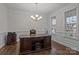 Home office with a large desk, hardwood floors, white trim, and windows providing natural light at 187 Longleaf Dr, Mooresville, NC 28117
