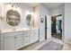 This bathroom features dual sinks and a vanity with tile flooring and a large mirror at 19010 Hawk Haven Ln, Charlotte, NC 28278