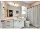 Neutral bathroom featuring a toilet, a large mirror, a vanity, and a shower with a curtain at 19010 Hawk Haven Ln, Charlotte, NC 28278