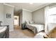 This neutral bedroom features crown molding, carpet, a bed, and is illuminated by natural light at 19010 Hawk Haven Ln, Charlotte, NC 28278