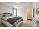 This bedroom features neutral paint, carpet, a light wood bedframe, and light blue bedding at 19010 Hawk Haven Ln, Charlotte, NC 28278