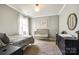 This neutral bedroom features a light fixture, carpet, a crib, a bed, and a dresser at 19010 Hawk Haven Ln, Charlotte, NC 28278