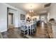 Spacious dining area open to kitchen with dining table and chairs and wood flooring at 19010 Hawk Haven Ln, Charlotte, NC 28278