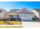 Charming single-story home featuring a well-manicured lawn, an attached two-car garage, and a stylish blue front door at 19010 Hawk Haven Ln, Charlotte, NC 28278