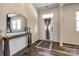 Elegant home entryway with hardwood floors, a stylish mirror, and a charming rug, creating a welcoming ambiance at 19010 Hawk Haven Ln, Charlotte, NC 28278