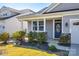 Beautiful home exterior with lush landscaping, a blue front door, and a welcoming porch area, creating curb appeal at 19010 Hawk Haven Ln, Charlotte, NC 28278