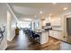 Open-concept kitchen with a large island, modern appliances, white cabinets, and seamless flow to the living spaces at 19010 Hawk Haven Ln, Charlotte, NC 28278