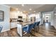 Modern kitchen featuring stainless steel appliances, white cabinetry, a large island, and sleek granite countertops at 19010 Hawk Haven Ln, Charlotte, NC 28278