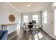 Bright home office with a work desk, natural light from windows, and modern decor at 19010 Hawk Haven Ln, Charlotte, NC 28278