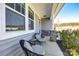 Inviting front porch featuring comfortable seating and decorative stone supports, perfect for enjoying the outdoors at 19010 Hawk Haven Ln, Charlotte, NC 28278