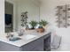 Modern bathroom featuring gray cabinets, a white countertop, a large mirror, stylish decor, and a clear seat at 2100 Endeavor Run, Charlotte, NC 28269