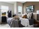 Stylish bedroom showcasing a comfortable bed with decorative pillows and a modern clothing rack at 2100 Endeavor Run, Charlotte, NC 28269