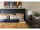 Comfortable bedroom featuring a king-size bed, decorative pillows, stylish bedside tables, and unique wall art at 2100 Endeavor Run, Charlotte, NC 28269