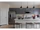Bright kitchen featuring gray cabinetry, stainless steel appliances, white countertops, and three pendant lights above the island at 2100 Endeavor Run, Charlotte, NC 28269