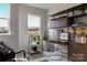 Bright office space with built-in shelving, modern decor, and a bar cart offering a functional and stylish workspace at 2100 Endeavor Run, Charlotte, NC 28269