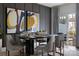 Elegant dining room with modern art, stylish chairs, dark gray walls, and a view of the outdoor patio at 2108 Endeavor Run, Charlotte, NC 28269