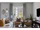 Bright living room featuring stylish curtains, neutral furniture, modern decor, and view of the outdoors at 2108 Endeavor Run, Charlotte, NC 28269