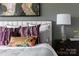 Stylish bedroom showcasing decorative pillows, gray textured bedding, and a modern nightstand at 2108 Endeavor Run, Charlotte, NC 28269