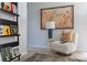 Cozy sitting area featuring a unique chair, patterned rug, modern lamp, and stylish decor at 2108 Endeavor Run, Charlotte, NC 28269