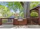 Backyard featuring wood deck, grill, nature, storage, and wooden structure at 2125 Kenilworth Ave, Charlotte, NC 28203