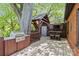 Backyard featuring wood deck, grill, outdoor TV, sitting area, storage, and wooden structure at 2125 Kenilworth Ave, Charlotte, NC 28203