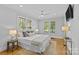 Bright bedroom with hardwood floors, ceiling fan, neutral paint, and large windows providing natural light at 2125 Kenilworth Ave, Charlotte, NC 28203