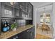 Charming built-in hutch featuring glass door cabinets and drawers adjacent to a dining room with hardwood floors at 2125 Kenilworth Ave, Charlotte, NC 28203