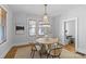 Elegant dining room featuring a chandelier, hardwood floors, and neutral colored walls at 2125 Kenilworth Ave, Charlotte, NC 28203