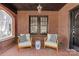 Cozy front porch with brick flooring, comfortable seating, and view of the front yard at 2125 Kenilworth Ave, Charlotte, NC 28203