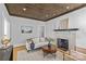 Bright living room features a decorative fireplace, hardwood floors, and neutral color palette at 2125 Kenilworth Ave, Charlotte, NC 28203