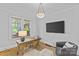 Bright office space with a work desk, hardwood floors, and a comfortable seating area illuminated by natural light at 2125 Kenilworth Ave, Charlotte, NC 28203