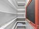 Organized pantry with white shelving, floral patterned shelf lining, and a chalkboard for a charming touch at 2125 Kenilworth Ave, Charlotte, NC 28203