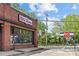 The brick exterior of a restaurant featuring large windows and outdoor signage on a sunny day at 2125 Kenilworth Ave, Charlotte, NC 28203