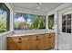 Bright sunroom with granite countertops, cabinets, wainscotting, and large windows with a view of nature at 2125 Kenilworth Ave, Charlotte, NC 28203