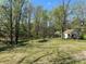 Spacious backyard featuring lush greenery and a shed at 215 Old Dixie Rd, Lancaster, SC 29720