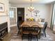Bright dining area with fireplace, chandelier lighting, and modern decor, perfect for Gathering meals and gatherings at 215 Old Dixie Rd, Lancaster, SC 29720