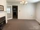 Empty living room with fireplace, French doors, and chandelier offers customization at 215 Old Dixie Rd, Lancaster, SC 29720