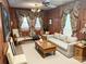 Cozy living room with wood paneling, decorative drapes, neutral furniture, and vintage-inspired accents at 215 Old Dixie Rd, Lancaster, SC 29720