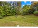 Lush backyard featuring a well-maintained lawn and raised garden beds, ideal for gardening at 2281 Old Salisbury Concord Rd, Concord, NC 28025