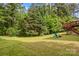 Large backyard with wooden deck, fire pit, mature trees, and plenty of green space at 2281 Old Salisbury Concord Rd, Concord, NC 28025