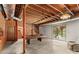 Unfinished basement with exposed wood ceiling, concrete floor, and walkout access to the backyard at 2281 Old Salisbury Concord Rd, Concord, NC 28025
