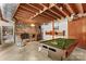 Finished basement area featuring a brick fireplace, pool table, and exposed wood ceiling at 2281 Old Salisbury Concord Rd, Concord, NC 28025