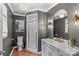 Well-lit bathroom with grey walls features modern fixtures, hexagon tile flooring, and a glass enclosed shower at 2281 Old Salisbury Concord Rd, Concord, NC 28025