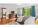 Bright bedroom with hardwood floors, large window, and classic dresser that create an inviting atmosphere at 2281 Old Salisbury Concord Rd, Concord, NC 28025