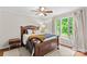Relaxing bedroom showcases hardwood floors, ceiling fan, and a large window that floods the room with light at 2281 Old Salisbury Concord Rd, Concord, NC 28025