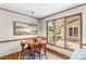 Bright dining area features modern lighting and an inviting round wooden table and floor to ceiling windows at 2281 Old Salisbury Concord Rd, Concord, NC 28025